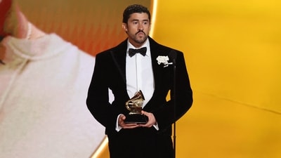 Bad Bunny accepts the award for Best Musica Urbana Album for "Debi Tirar Mas Fotos" during the 68th Annual Grammy Awards. The singer chose a custom Schiaparelli couture suit for the special occasion. The velvet suit, tailored with a corseted waist, looked nothing short of spectacular.&nbsp; (REUTERS)