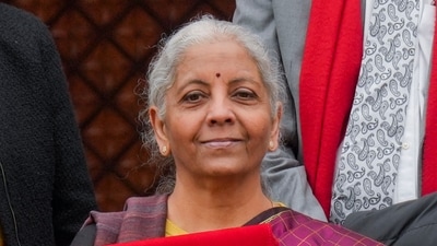 Finance Minister Nirmala Sitharaman shows the digital tablet, enclosed in a traditional red 'bahi-khata' style pouch, at the Parliament premises before presenting of the Union Budget 2026-27, in New Delhi, Sunday, Feb. 1, 2026. (PTI) Finance Minister Nirmala Sitharaman shows the digital tablet, enclosed in a traditional red 'bahi-khata' style pouch, at the Parliament premises before presenting of the Union Budget 2026-27, in New Delhi, Sunday, Feb. 1, 2026. (PTI)
