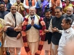 Prime Minister Narendra Modi greets after being garlanded at the NDA Parliamentary party meeting at GMC Balayogi Auditorium, at the Parliament Library building in the Parliament premises, in New Delhi on Tuesday. 