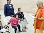 Chief minister Yogi Adityanath interacts with the girl during the Janata Darshan, in Lucknow on Monday. (Sourced)