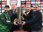 Pakistan's captain Salman Agha receives the trophy from Pakistan Cricket Board chairman Mohsin Naqvi.