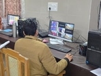 A team member monitors strongrooms at different examination centres in state, from the control room in UP Board headquarters in Prayagraj on Thursday. (HT Photo)