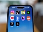 Instagram, TikTok, Snapchat, Kick, YouTube, Facebook, Twitch, Reddit, Threads and X applications are displayed on a mobile phone.