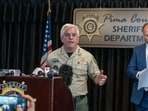  Pima County Sheriff, Chris Nanos (left), speaks to the media on February 3, 2026 in Tucson, Arizona