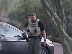 Pima County Sheriff’s deputies walk through the driveway of Nancy Guthrie's home