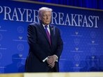 Donald Trump prays during a group prayer during the National Prayer Breakfast