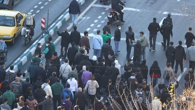 Shopkeepers and traders protest in the street against the economic conditions and Iran's embattled currency in Tehran on December 29 (AFP) Shopkeepers and traders protest in the street against the economic conditions and Iran's embattled currency in Tehran on December 29 (AFP)