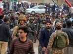 Pakistani paramilitary soldiers control a crowd close to the site of a bomb explosion at a Shiite mosque, in Islamabad, Pakistan.