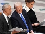 Former President Barack Obama talks with then President-elect Donald Trump as Melania Trump reads the funeral program before the state funeral for former President Jimmy Carter at Washington National Cathedral in Washington, Jan. 9, 2025. Former President Barack Obama talks with then President-elect Donald Trump as Melania Trump reads the funeral program before the state funeral for former President Jimmy Carter at Washington National Cathedral in Washington, Jan. 9, 2025.