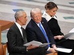 Former President Barack Obama talks with Donald Trump