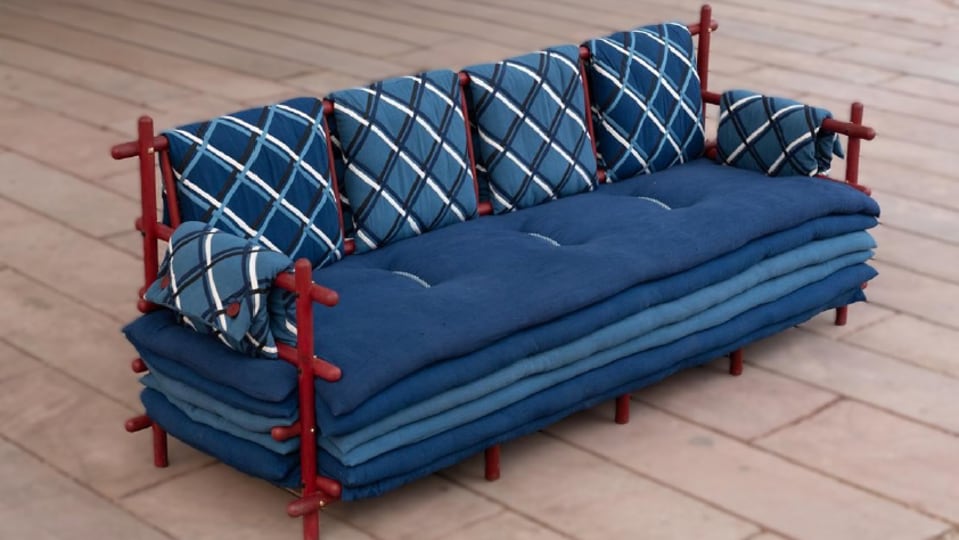 An indigo mattress sofa with a red-stained wooden frame is priced at ₹12 lakh. An indigo mattress sofa with a red-stained wooden frame is priced at ₹12 lakh.