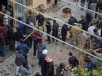 Pakistani security officials examine the site of of a bomb explosion at a Shiite mosque, in Islamabad, Pakistan,
