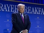 Donald Trump prays during a group prayer during the National Prayer Breakfast.