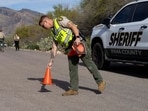 A Pima County Sheriff’s Office deputy sets up a roadblock a few houses down from the home of Nancy Guthrie, the 84-year-old mother of U.S. journalist and television host Savannah Guthrie, who went missing from her home in Tucson, U.S. February 6, 2026.  REUTERS/Rebecca Noble