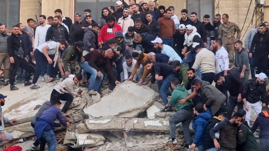 Rescue workers and residents search for survivors in the rubble of a building that collapsed in the northern city of Tripoli, Lebanon, Sunday, Feb. 8, 2026. (AP)