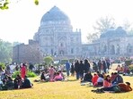 People enjoying the sun on a winter morning at Lodhi Garden in New Delhi.