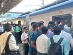Mumbai, India - October 03, 2022: Scores of commuters stranded at the Borivali station as they had a harrowing time on Monday morning, the first day of revised air-conditioned local services on the Western line. Commuters struggle to board the packed AC local train on Monday at 7.45am from Borivali station. It was only after the police intervened and asked a few commuters to alight did the train move. (HT Photo) (Hindustan Times)