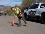 A Pima County Sheriff’s Office deputy sets up a roadblock a few houses down from the home of Nancy Guthrie, the 84-year-old mother of US journalist and television host Savannah Guthrie, who went missing from her home in Tucson.