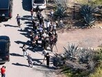 TUCSON, ARIZONA - FEBRUARY 8: In an aerial view, investigators walk through a crowd of media gathered outside of the home of Nancy Guthrie on February 8, 2026 in Tucson, Arizona. (Photo by Rebecca Noble / GETTY IMAGES NORTH AMERICA / Getty Images via AFP)