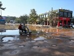 The cratered road near HUDA market of Sector 56 flooded with sewage water as seen on February 06. (Parveen Kumar/HT)