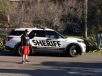 A man livestreams near the home of Nancy Guthrie, the 84-year-old mother of U.S. journalist and television host Savannah Guthrie, who went missing from her home in Tucson, U.S. February 9, 2026.  REUTERS/Rebecca Noble