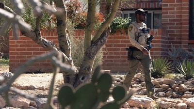 A Pima County Sheriff's Department deputy patrols the home of Nancy Guthrie. (REUTERS)