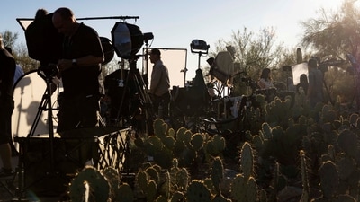 Broadcast journalists give live reports outside the home of Nancy Guthrie. (REUTERS)