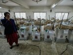 An official stands near ballot boxes and voting papers before its distribution to various polling centers ahead of Thursday's national parliamentary election, in Dhaka, Bangladesh. An official stands near ballot boxes and voting papers before its distribution to various polling centers ahead of Thursday's national parliamentary election, in Dhaka, Bangladesh.