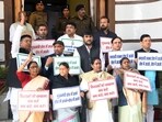 Opposition members protest outside Bihar Legislative Council in Patna, Wednesday (SANTOSH KUMAR/HT)