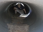 An investigator looks inside a culvert in the neighborhood where Annie Guthrie, whose mother Nancy Guthrie has been missing for more than a week, lives just outside Tucson, Arizona.