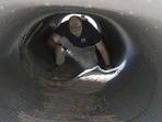 An investigator looks inside a culvert in the neighborhood where Annie Guthrie, whose mother Nancy Guthrie has been missing for more than a week, lives just outside Tucson, Arizona.