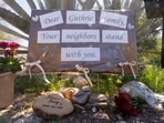 A sign and other objects showing support from neighbors is posted at the home of Nancy Guthrie, the 84-year-old mother of U.S. journalist and television host Savannah Guthrie, who went missing from her home in Tucson.
