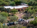TUCSON, ARIZONA - FEBRUARY 10: In an aerial view, law enforcement and news broadcasters are stationed outside of Nancy Guthrie's residence on February 10, 2026 in Tucson, Arizona. (Photo by Brandon Bell / GETTY IMAGES NORTH AMERICA / Getty Images via AFP)