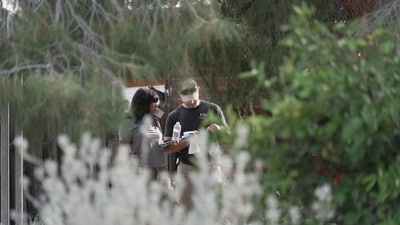 Investigators look over paperwork in the neighborhood where Annie Guthrie, whose mother Nancy Guthrie has been missing for more than a week, lives just outside Tucson, Ariz., on Tuesday, Feb. 10, 2026. (AP Photo/Ty ONeil) (AP) Investigators look over paperwork in the neighborhood where Annie Guthrie, whose mother Nancy Guthrie has been missing for more than a week, lives just outside Tucson, Ariz., on Tuesday, Feb. 10, 2026. (AP Photo/Ty ONeil) (AP)