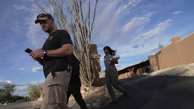 Law enforcement agents walk around the neighborhood where Annie Guthrie, whose mother Nancy Guthrie has been missing for more than a week, lives just outside Tucson, Ariz. (AP Photo/Ty ONeil) (AP) Law enforcement agents walk around the neighborhood where Annie Guthrie, whose mother Nancy Guthrie has been missing for more than a week, lives just outside Tucson, Ariz. (AP Photo/Ty ONeil) (AP)