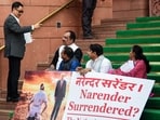 Union minister Kiren Rijiju interacts as suspended Lok Sabha MPs Prashant Yadaorao Padole and Dean Kuriakose protest outside Parliament during the ongoing Budget Session in New Delhi.