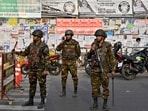 Members of the Bangladesh Army stand guard at a temporary checkpoint, a day ahead of the national election in Dhaka, Bangladesh. REUTERS/Fatima Tuj Johora
