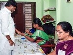 Telangana Deputy Chief Minister Bhatti Vikramarka Mallu gets an ink mark on his finger as he cast his vote for the municipal corporation elections at the Indira Dairy polling station within Madhira Municipality, in Khammam on Wednesday.