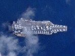 This handout satellite photo taken on December 3, 2025 shows the world's largest aircraft carrier, the USS Gerald Ford, with at least 40 fighter jets on its deck, off the coast of Saint Thomas, US Virgin Islands. 