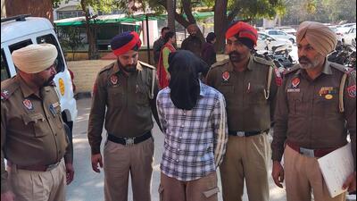 The 35-year-old murder accused, Prince Kumar, in police custody in Bathinda on Friday. (Sanjeev Kumar/HT)