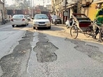 A damaged stretch of the Domoria Bridge road in Ludhiana. (Manish/HT) A damaged stretch of the Domoria Bridge road in Ludhiana. (Manish/HT)