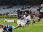 Kerala Blasters' Victor Bertomeu in action with Mohun Bagan Super Giant's goalkeeper Vishal Kaith during the Indian Super League in Kolkata, Saturday. (PTI)