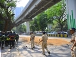 Police and rescue personnel inspect the site of accident after one person was killed and three others were injured when a portion of a parapet of an elevated under-construction metro train bridge fell and hit an auto rickshaw and a car on the LBS Road in Mumbai's Mulund