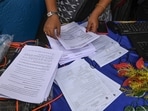 Election Commission officials assist voters at a help desk camp for the Special Intensive Revision (SIR) of Electoral Rolls, in Sonagachi, Kolkata.