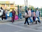 Pedestrians crossing the road outside the bus stand in Ludhiana on Saturday. (Manish/HT)
