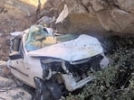 The mangled remains of the car that fell down the gorge in Himachal’s Kinnaur on Saturday. (HT Photo)