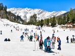 Tourists ski and take part in snow activities at Solang Valley, in Kullu district of Himachal Pradesh, on Saturday. (PTI)