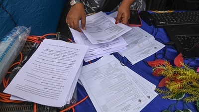 Election Commission officials assist voters at a help desk camp for the Special Intensive Revision (SIR) of Electoral Rolls, in Sonagachi, Kolkata. (PTI File) Election Commission officials assist voters at a help desk camp for the Special Intensive Revision (SIR) of Electoral Rolls, in Sonagachi, Kolkata. (PTI File)