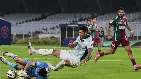 Kerala Blasters' Victor Bertomeu in action with Mohun Bagan Super Giant's goalkeeper Vishal Kaith during the Indian Super League in Kolkata, Saturday. (PTI)