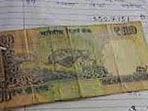 A currency note attached to answer-sheet. (FILE PHOTO)